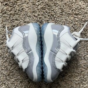 Jordan 11 low cement grey 2C shoes.